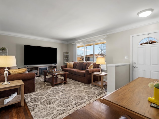 living area featuring ornamental molding and dark wood-style floors