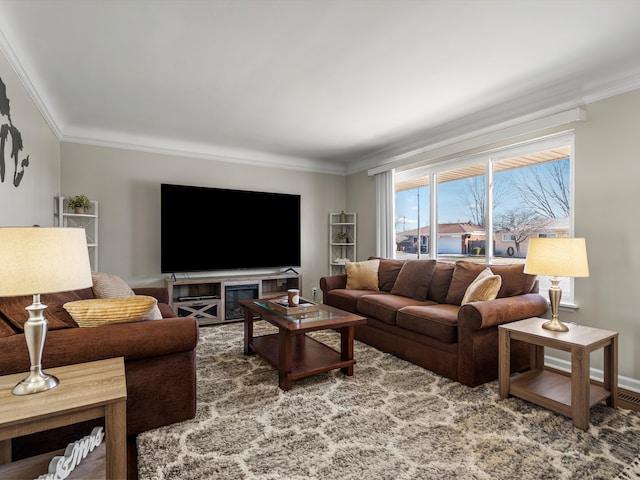 living area featuring baseboards and ornamental molding