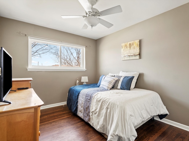 bedroom with ceiling fan, dark wood-style flooring, and baseboards