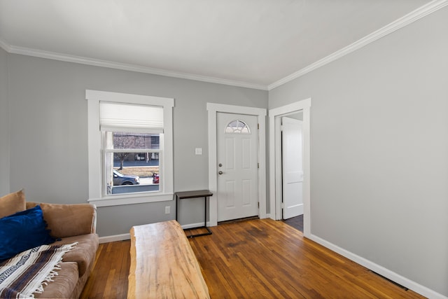 entryway with crown molding, wood-type flooring, and baseboards