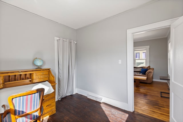 bedroom featuring visible vents, crown molding, baseboards, and wood finished floors