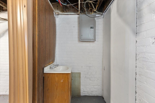 bathroom with concrete flooring, vanity, and electric panel