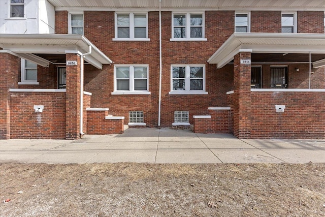 view of side of home featuring brick siding