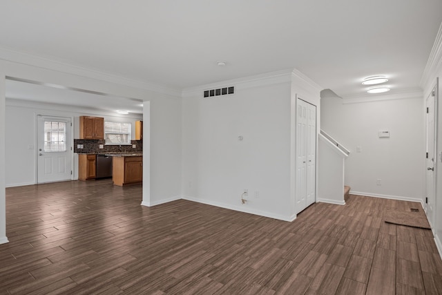 unfurnished living room with baseboards, visible vents, dark wood-type flooring, and ornamental molding