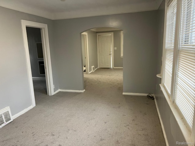 24067 Sargent Ave, Southfield, MI 48033 - unfurnished room featuring arched walkways, carpet flooring, plenty of natural light, and baseboards