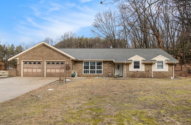 ranch-style house with a garage, a front yard, concrete driveway, and brick siding