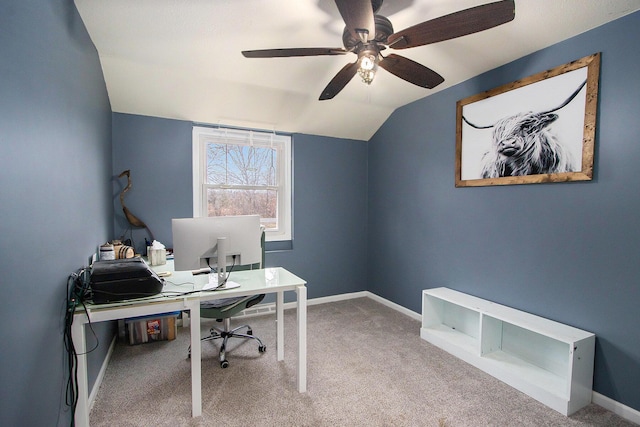 office space featuring lofted ceiling, a ceiling fan, baseboards, and carpet flooring