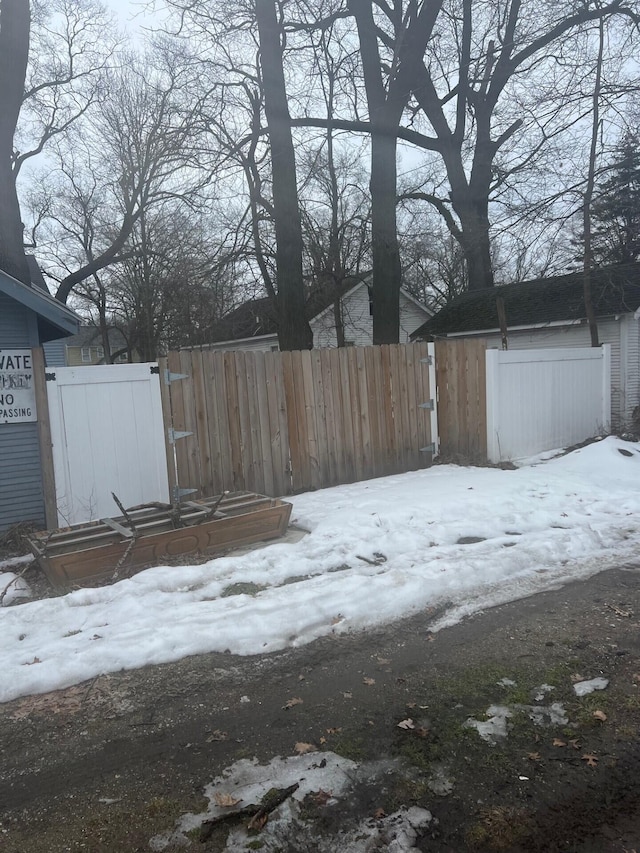 yard covered in snow featuring fence