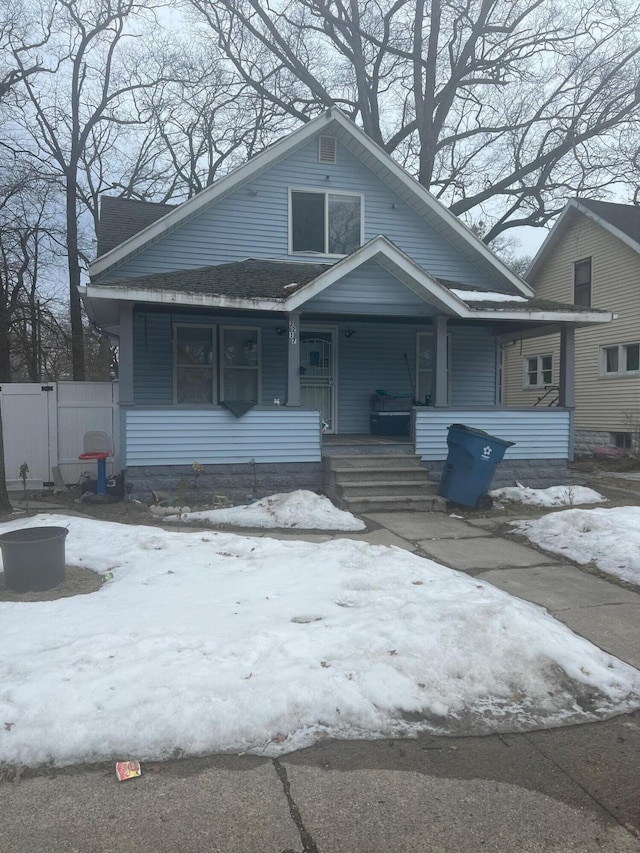 bungalow-style house featuring a porch and fence