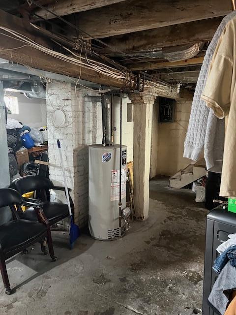 unfinished basement featuring gas water heater