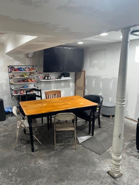 dining area featuring unfinished concrete floors