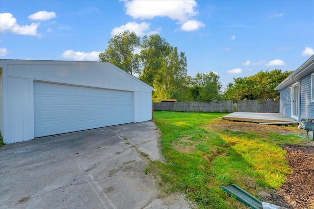 detached garage featuring fence