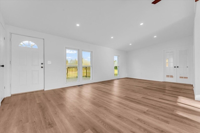 unfurnished living room featuring french doors, recessed lighting, visible vents, and light wood-style floors