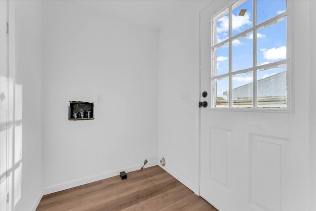 laundry room featuring laundry area, wood finished floors, and baseboards