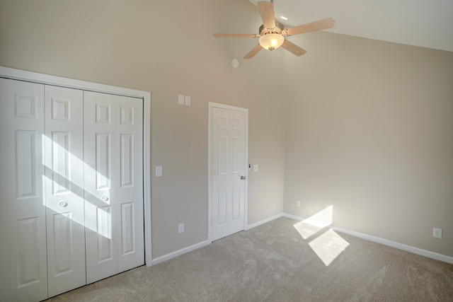 unfurnished bedroom with carpet flooring, ceiling fan, high vaulted ceiling, and baseboards