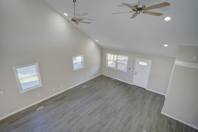 unfurnished living room featuring recessed lighting, baseboards, high vaulted ceiling, and wood finished floors