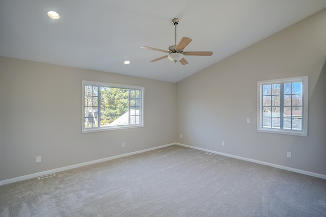 carpeted spare room with a wealth of natural light, visible vents, lofted ceiling, and recessed lighting