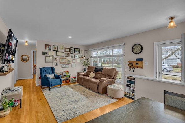 living room with light wood finished floors and recessed lighting