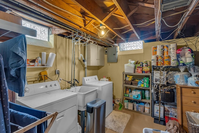 washroom featuring plenty of natural light, independent washer and dryer, a sink, and electric panel