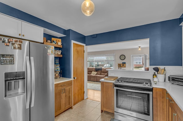 kitchen featuring open shelves, light countertops, backsplash, appliances with stainless steel finishes, and light tile patterned flooring