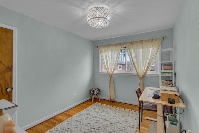 home office with wood finished floors and baseboards