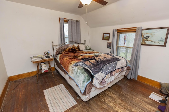 bedroom with vaulted ceiling, ceiling fan, hardwood / wood-style flooring, and baseboards