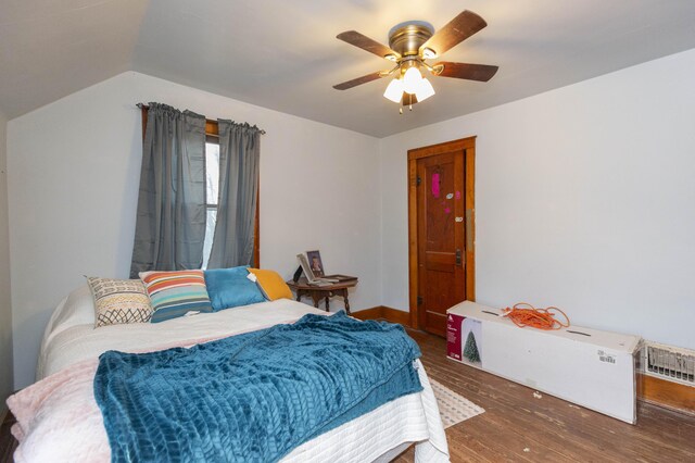 bedroom with ceiling fan, baseboards, vaulted ceiling, and wood finished floors