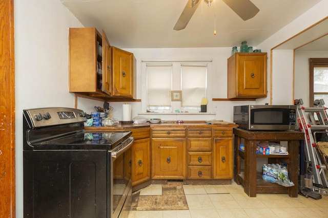 kitchen featuring brown cabinetry, stainless steel appliances, and a ceiling fan