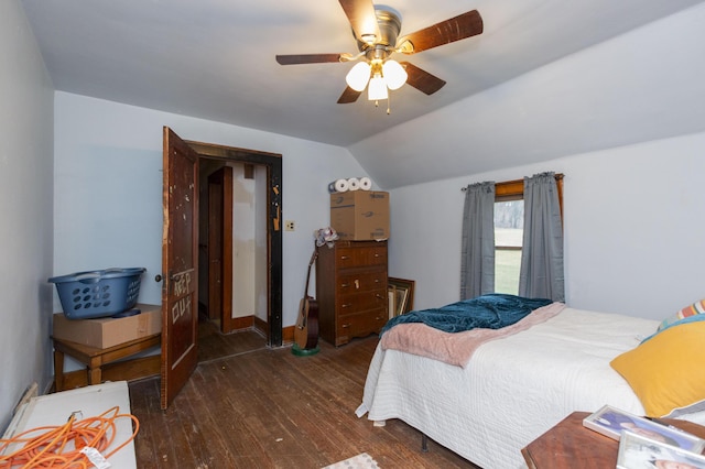 bedroom featuring a ceiling fan, lofted ceiling, and wood-type flooring