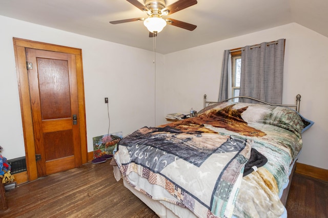 bedroom with a ceiling fan, baseboards, and wood finished floors