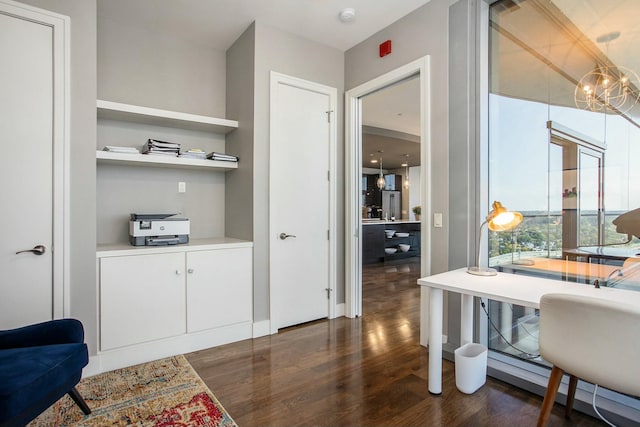 office area featuring a chandelier and dark wood-style flooring