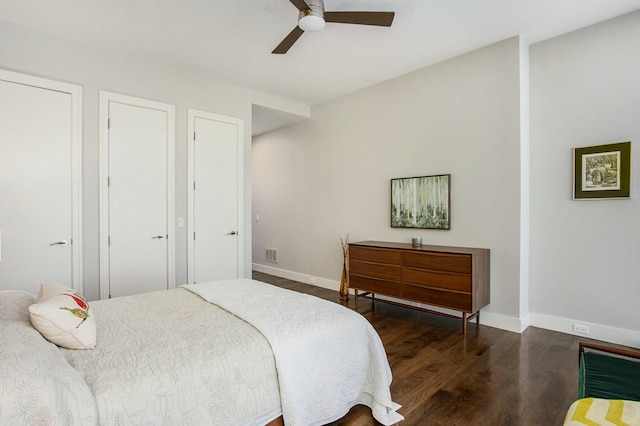 bedroom featuring ceiling fan, wood finished floors, visible vents, and baseboards