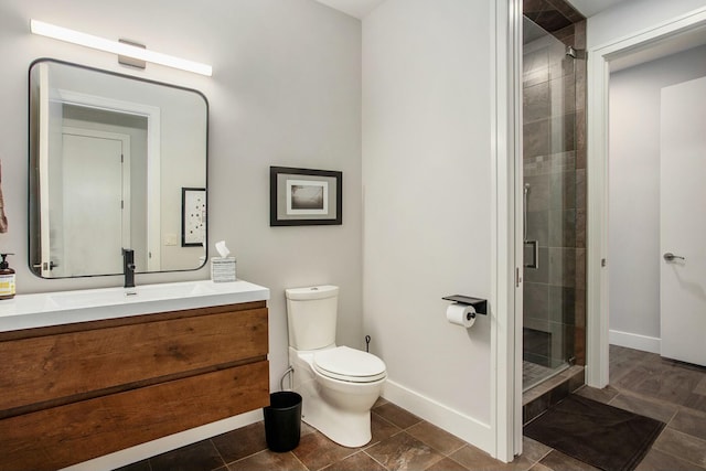 full bathroom featuring toilet, a stall shower, vanity, baseboards, and tile patterned floors