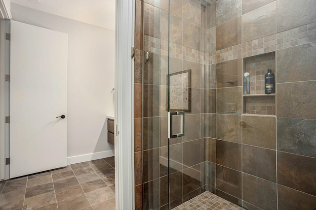 full bath with a stall shower and baseboards