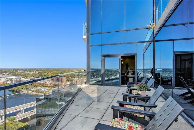 exterior space with a water view, a balcony, and a city view