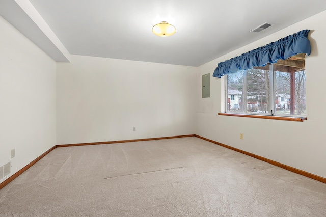 carpeted spare room featuring baseboards and visible vents