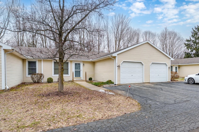 single story home featuring driveway and an attached garage