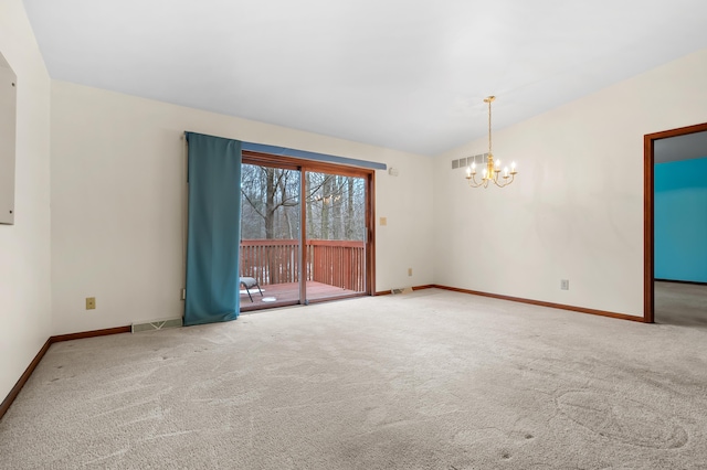 carpeted empty room with lofted ceiling, an inviting chandelier, baseboards, and visible vents