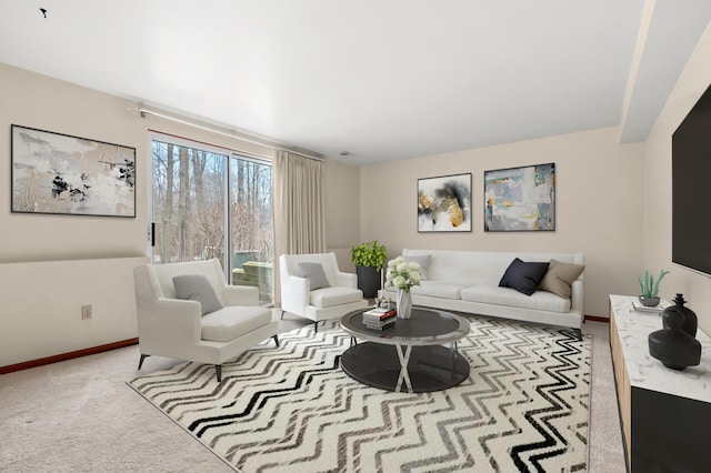 living area featuring carpet and baseboards