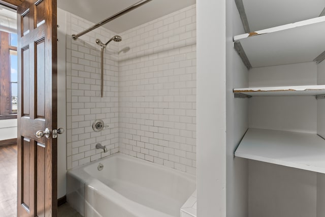 bathroom featuring shower / washtub combination and wood finished floors