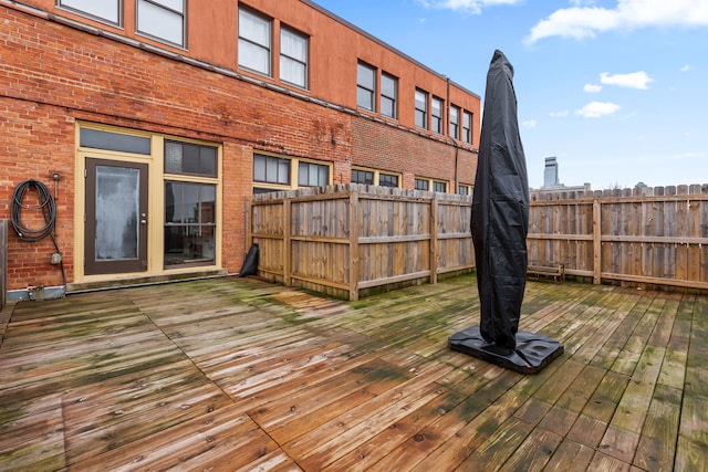 wooden terrace featuring fence