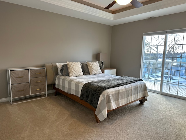 bedroom featuring ceiling fan, carpet flooring, visible vents, access to outside, and a raised ceiling