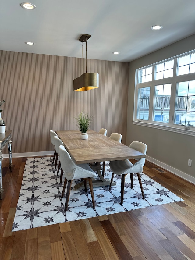 dining space with wallpapered walls, baseboards, wood finished floors, and recessed lighting