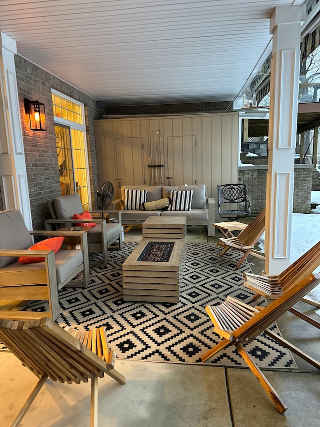 view of patio with an outdoor living space with a fire pit