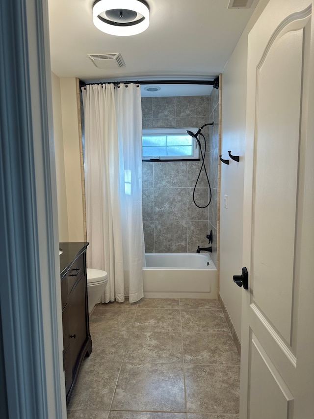 full bathroom with shower / bath combo, visible vents, vanity, and toilet