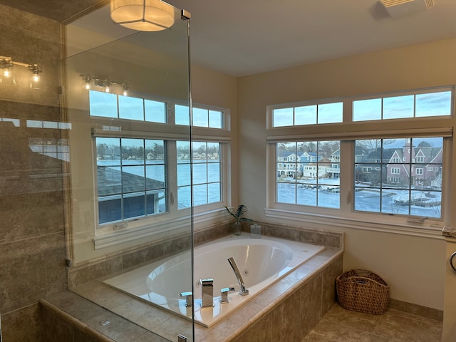 full bath with a whirlpool tub, tile patterned flooring, and visible vents