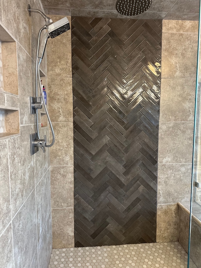 bathroom with a tile shower