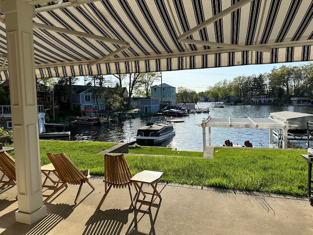 view of patio featuring a boat dock, area for grilling, and a water view