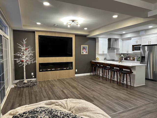 interior space featuring dark wood-style floors, a fireplace, baseboards, and recessed lighting