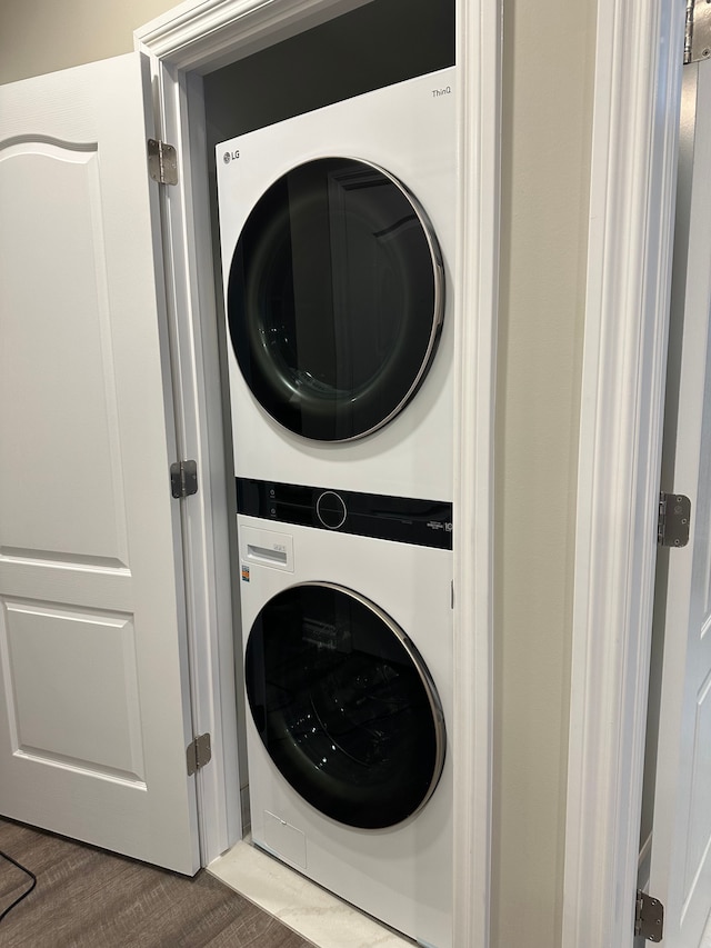 washroom featuring laundry area and stacked washing maching and dryer